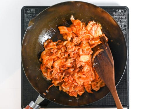 Stir-frying buta kimchi in a wok