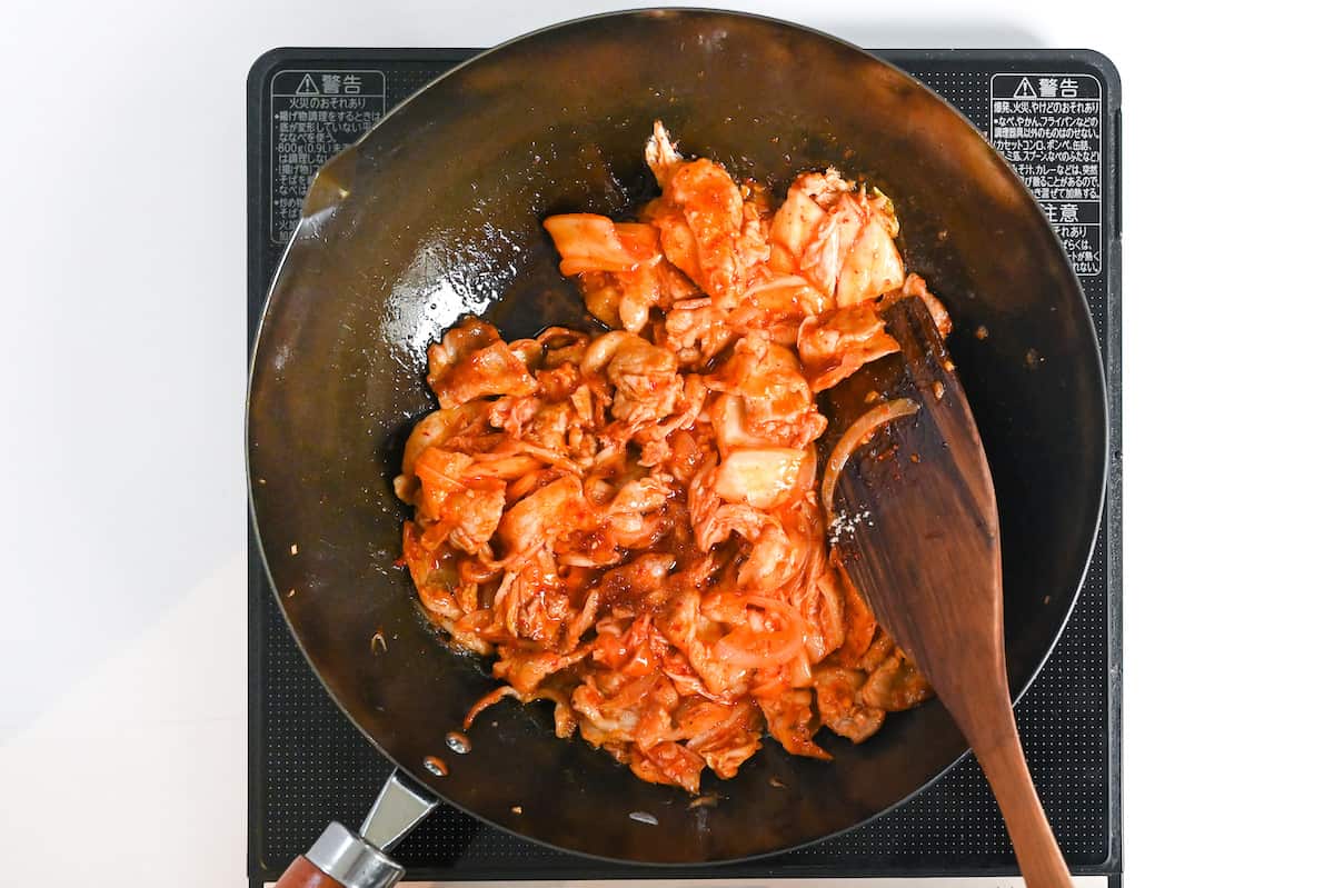 Stir-frying buta kimchi in a wok