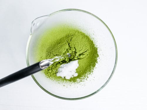 pouring hot water into sifted matcha and sugar