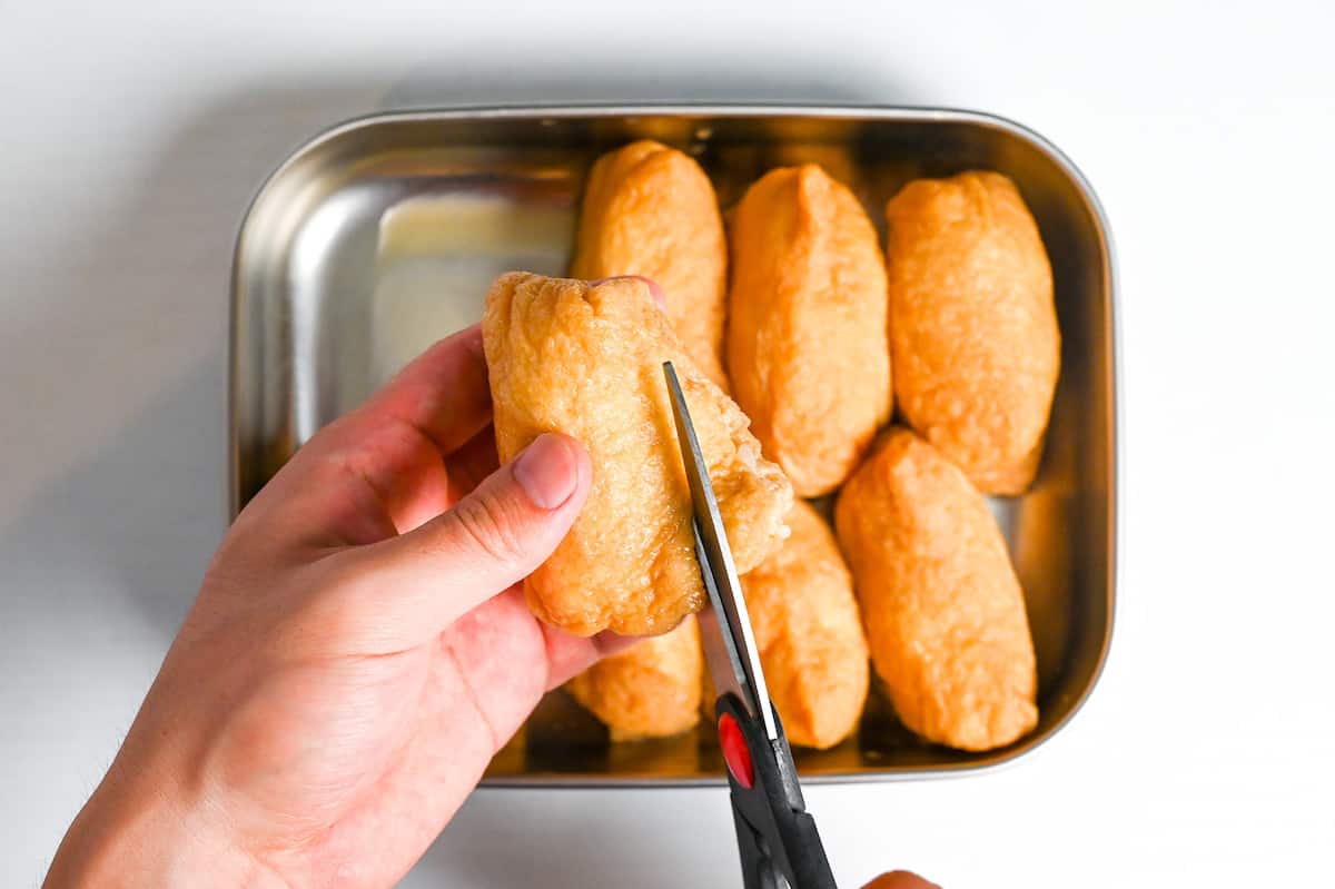 trimming end of tofu pouch to add extra fillings to inarizushi