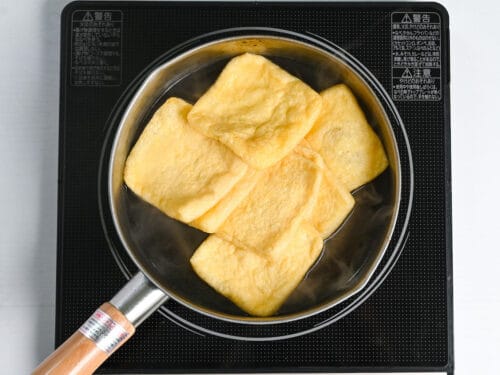 boiling aburaage (fried tofu touches) in water