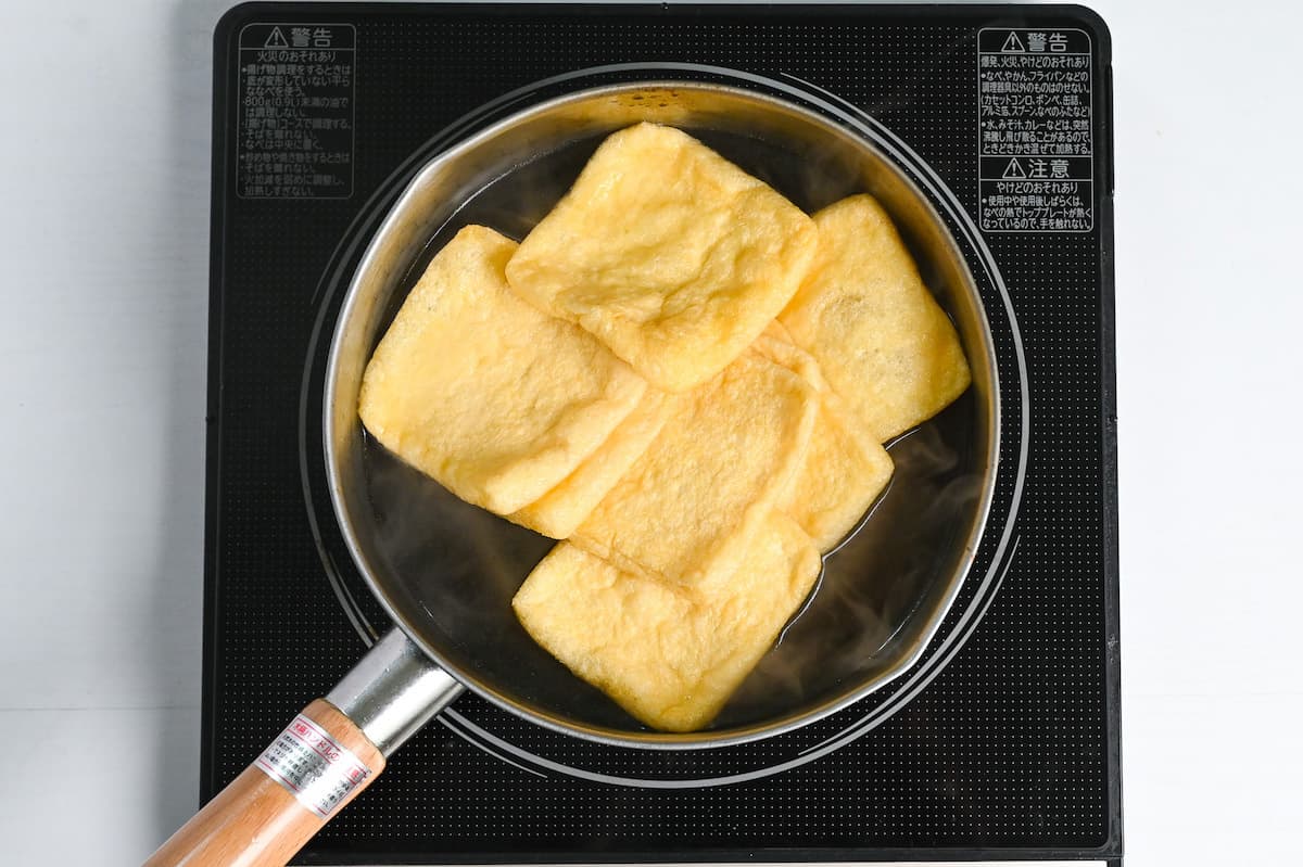 boiling aburaage (fried tofu touches) in water