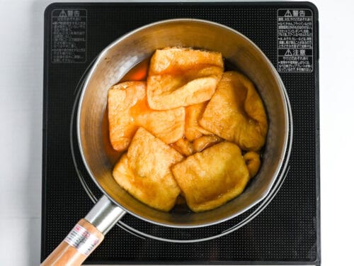 simmering aburaage (fried tofu pouch) in sweet marinade