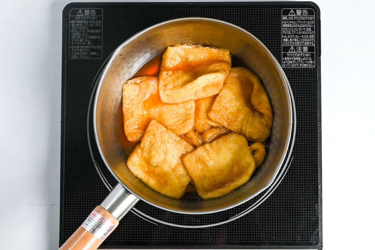 simmering aburaage (fried tofu pouch) in sweet marinade