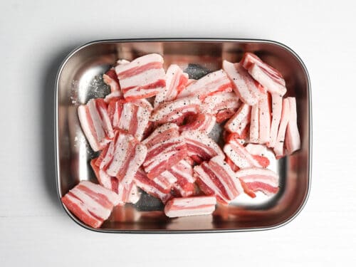 thick slices of pork belly seasoned with salt and pepper