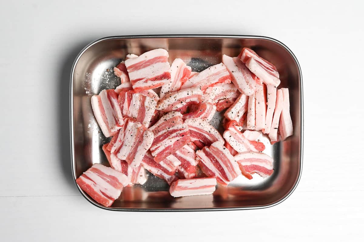 thick slices of pork belly seasoned with salt and pepper