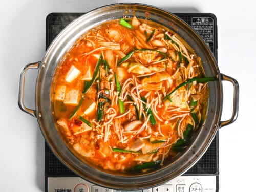 kimchi nabe cooking in an aluminum pot