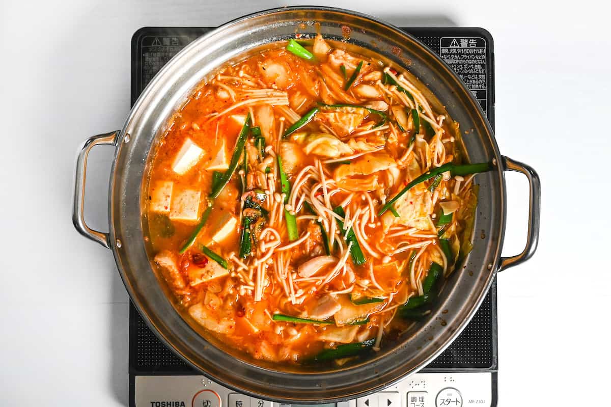 kimchi nabe cooking in an aluminum pot