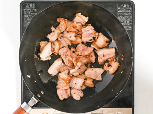 stir frying pork belly in a wok