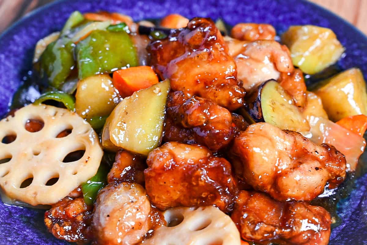 Ootoya style tori to yasai no kurozu an (Japanese black vinegar sweet and sour chicken and vegetables) on a blue plate - close up