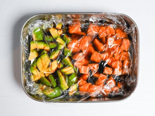 marinating avocado and sashimi-grade salmon in a container