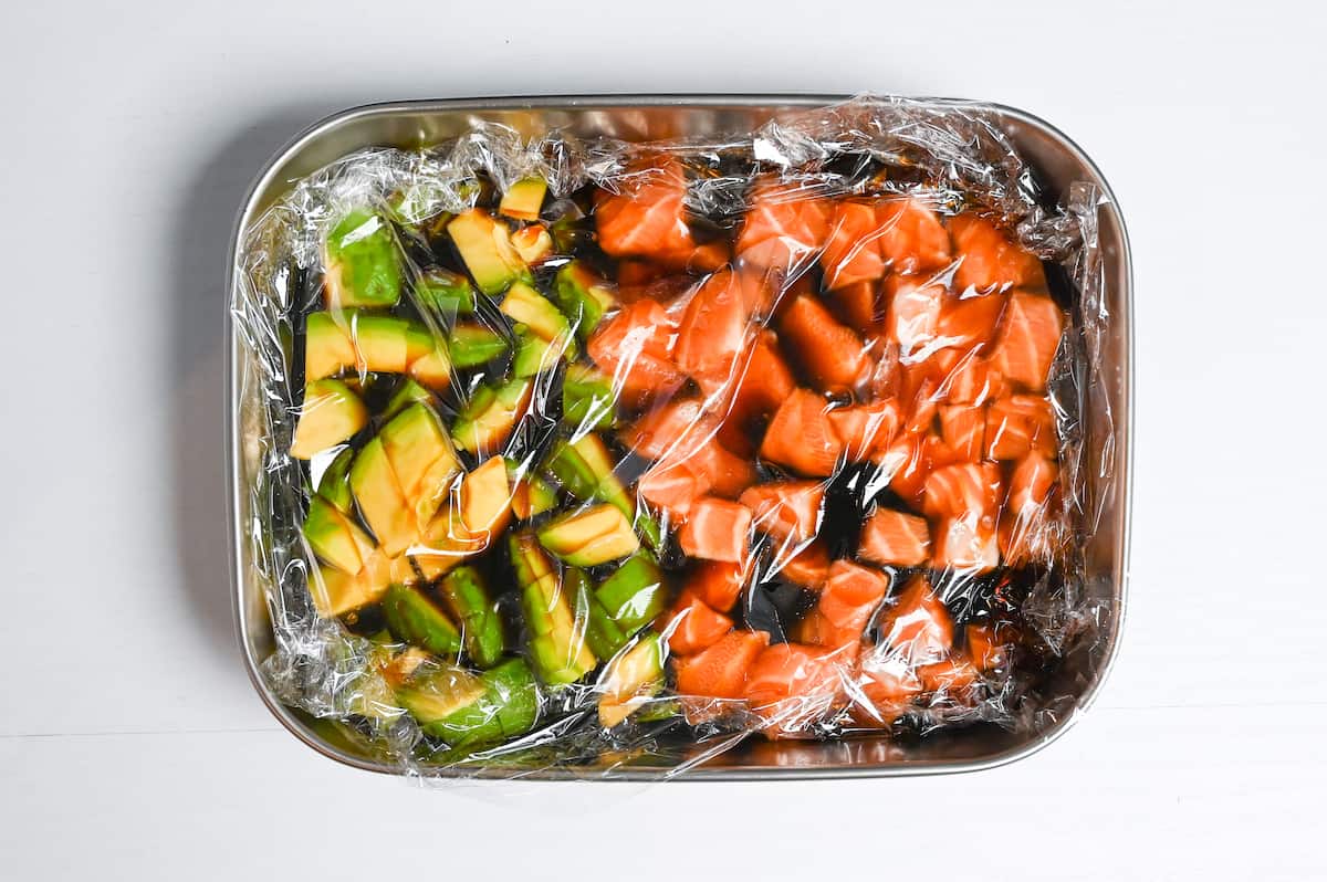 marinating avocado and sashimi-grade salmon in a container