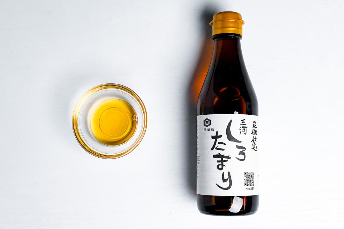a bottle of shiro tamari from Mikawa region next to a small amount poured into a glass bowl