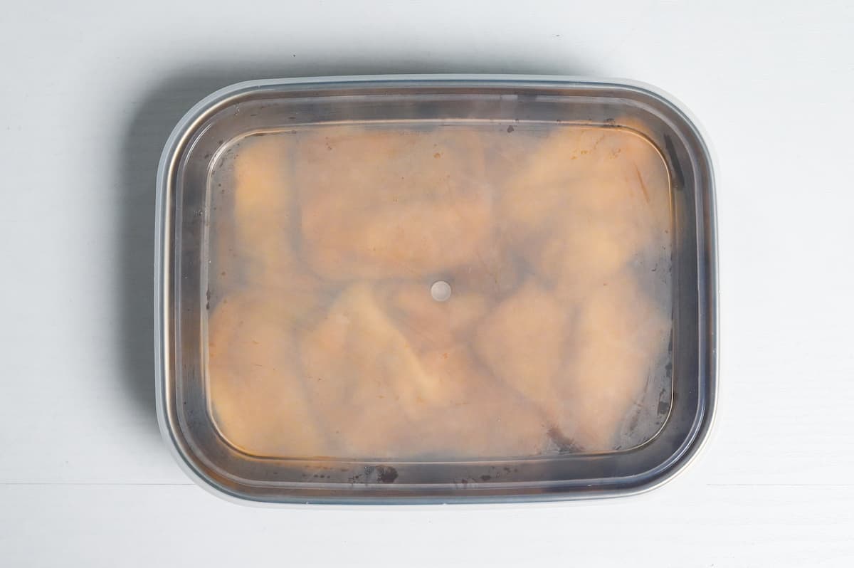 aburaage (fried tofu pouch) marinating in sealed container with lid