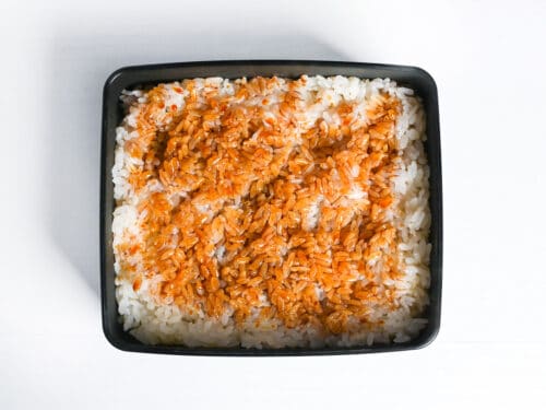 rice in a lacquerware box brushed with unagi (kabayaki) sauce
