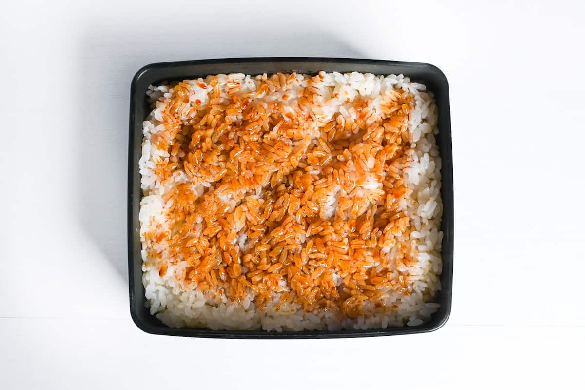 rice in a lacquerware box brushed with unagi (kabayaki) sauce
