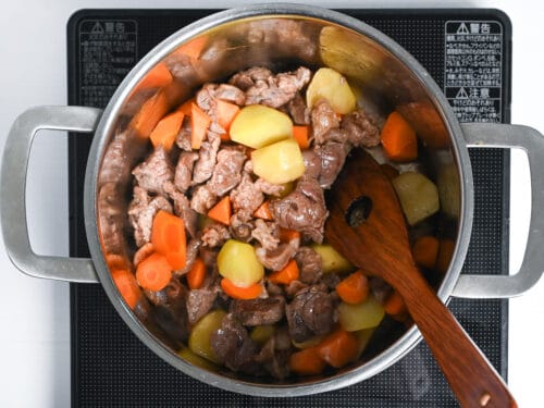 sealed beef in a pot with potato, carrot and soy sauce