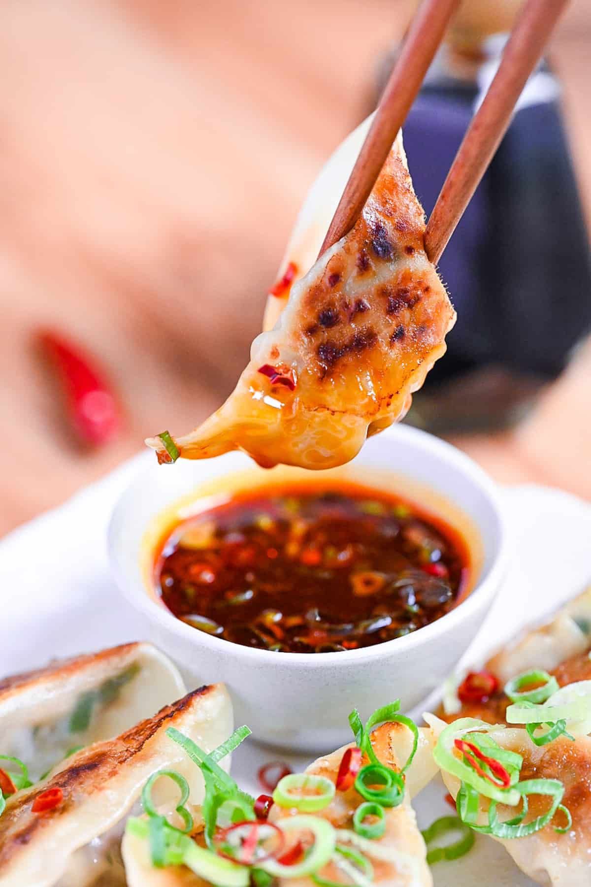 dipping beef gyoza in hot dipping sauce