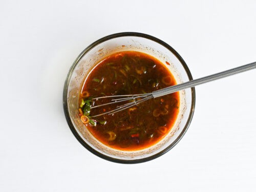 homemade hot gyoza dipping sauce in a glass bowl