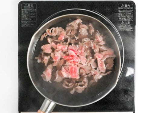 blanching thinly sliced wagyu beef in hot water