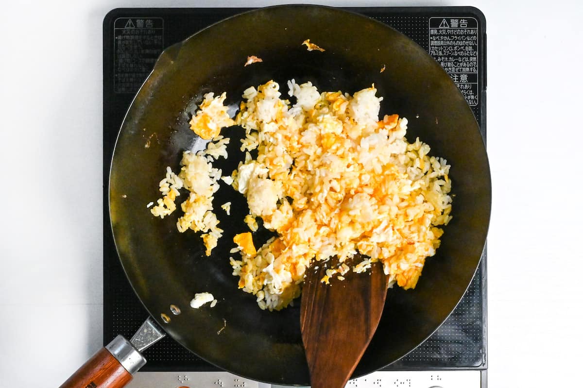 egg and rice frying in a wok