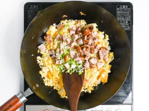 roughly cubed kamaboko, chashu and chopped green onion added to fried rice (chahan)
