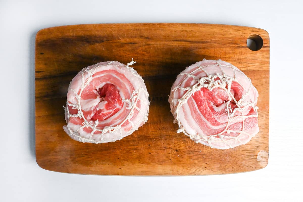 2 pork belly blocks rolled and wrapped with butchers string nets