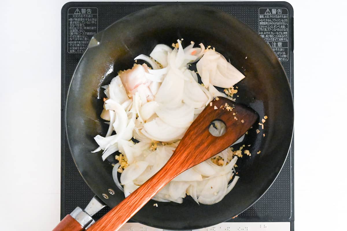 frying onion with garlic, ginger and beef fat