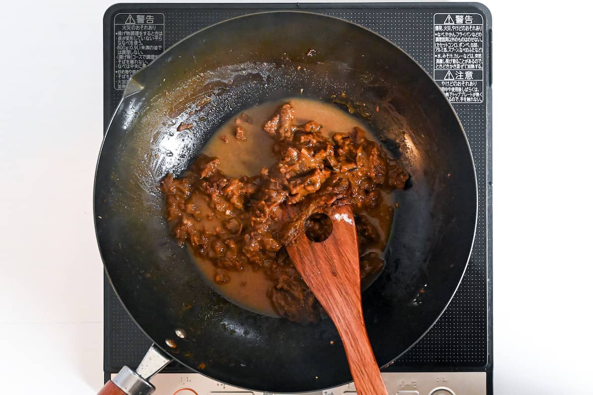 gradually adding beef stock to curry roux, mixing until smooth