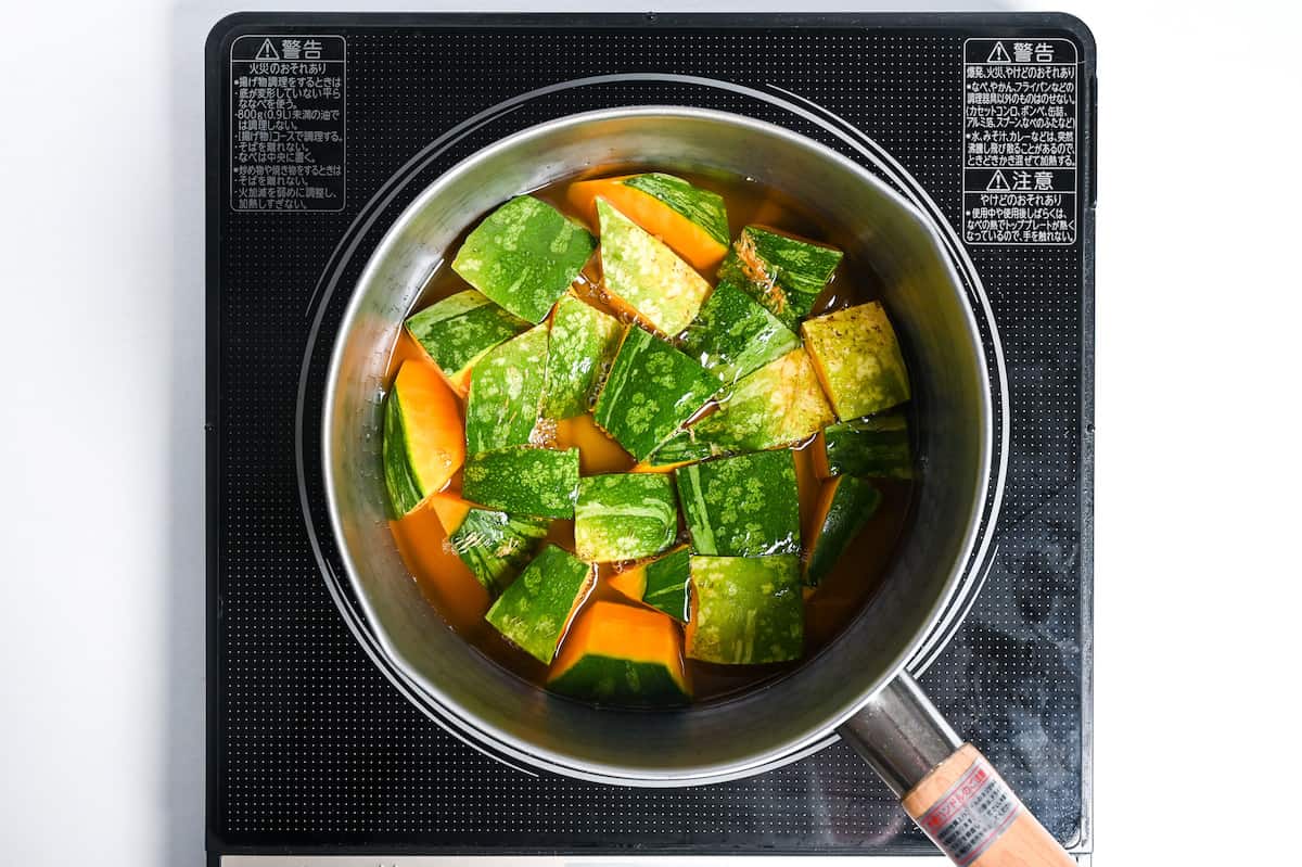 Kabocha Japanese squash in dashi in a saucepan