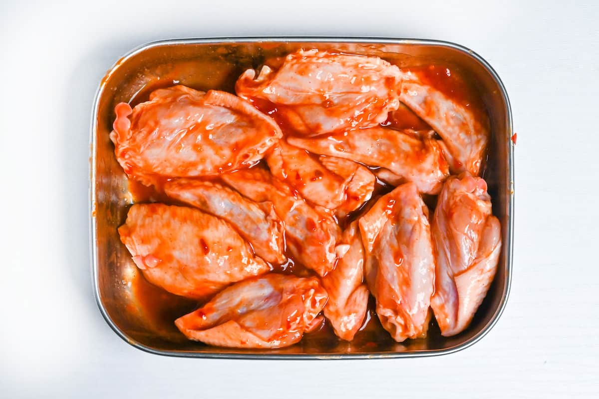 chicken wingettes coated in marinade to make karami chicken