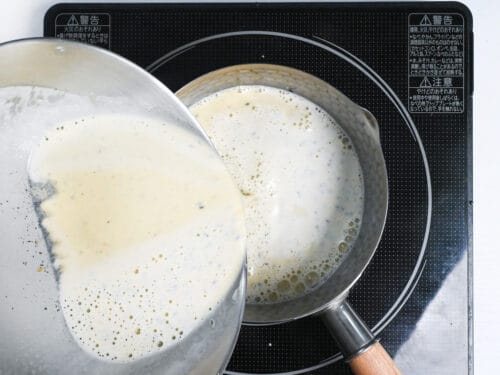 pouring sesame ice cream mixture into a sauce pan