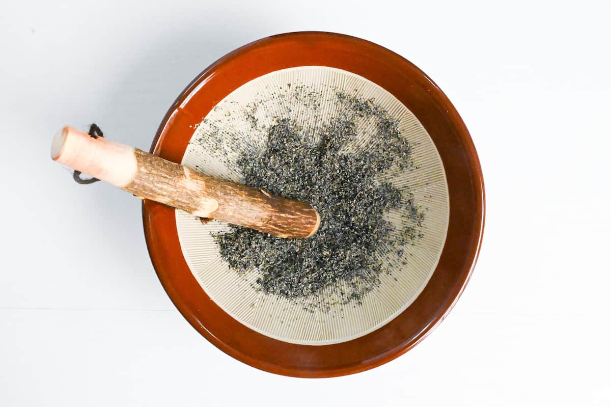 ground black sesame seeds with mortar and pestle