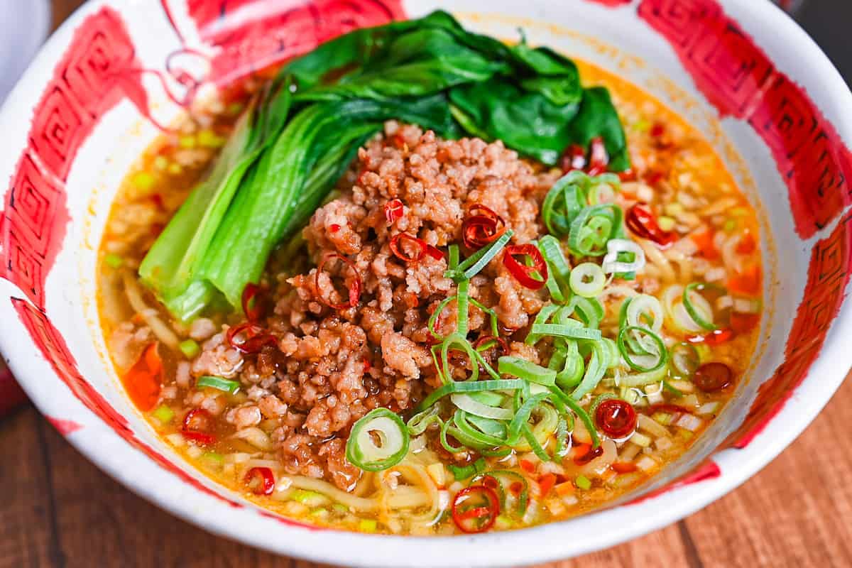 Spicy Japanese style tantanmen ramen in a red and white bowl