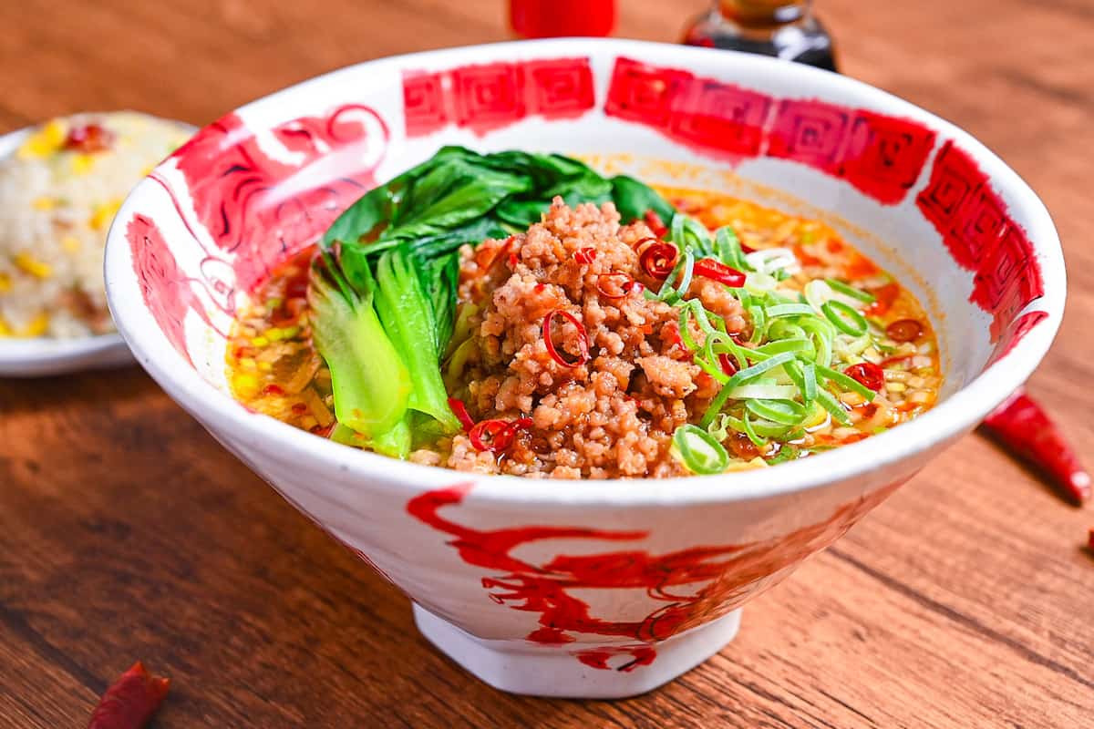 Spicy Japanese style tantanmen ramen in a red and white bowl