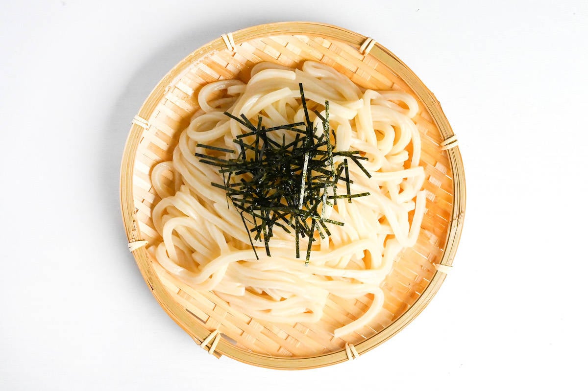cold udon noodles on a bamboo zaru topped with shreds of nori (kizami nori)