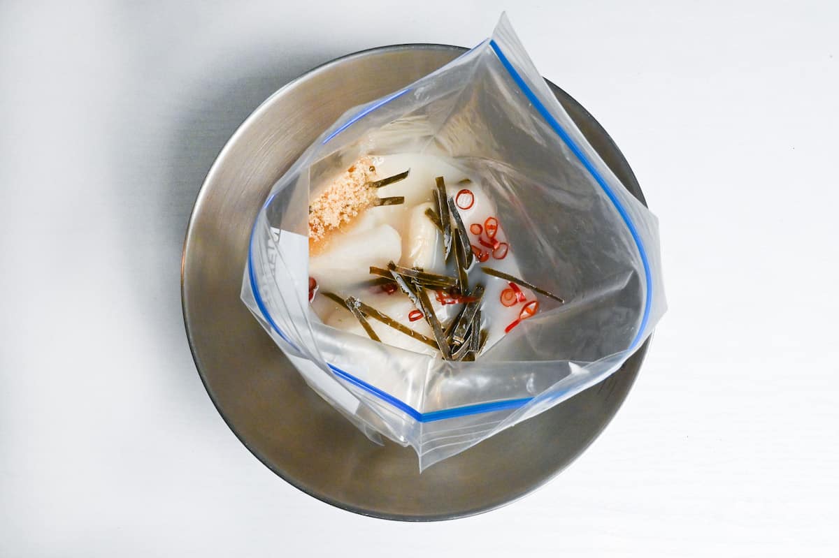 daikon radish in a sealable freezer bag with amazake, kombu, dried chili, sugar and salt.