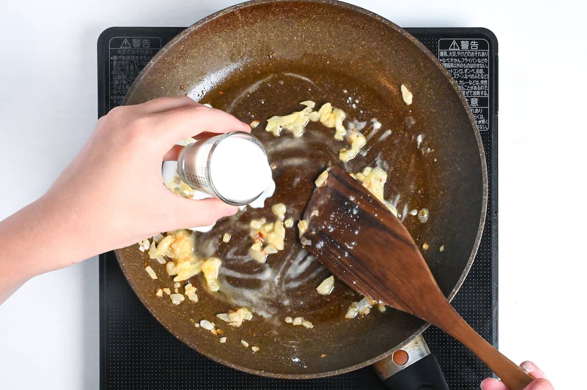 adding milk to pan to make a roux