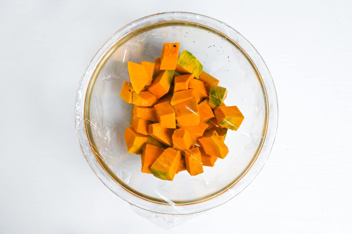 cubed kabocha in a glass bowl with water