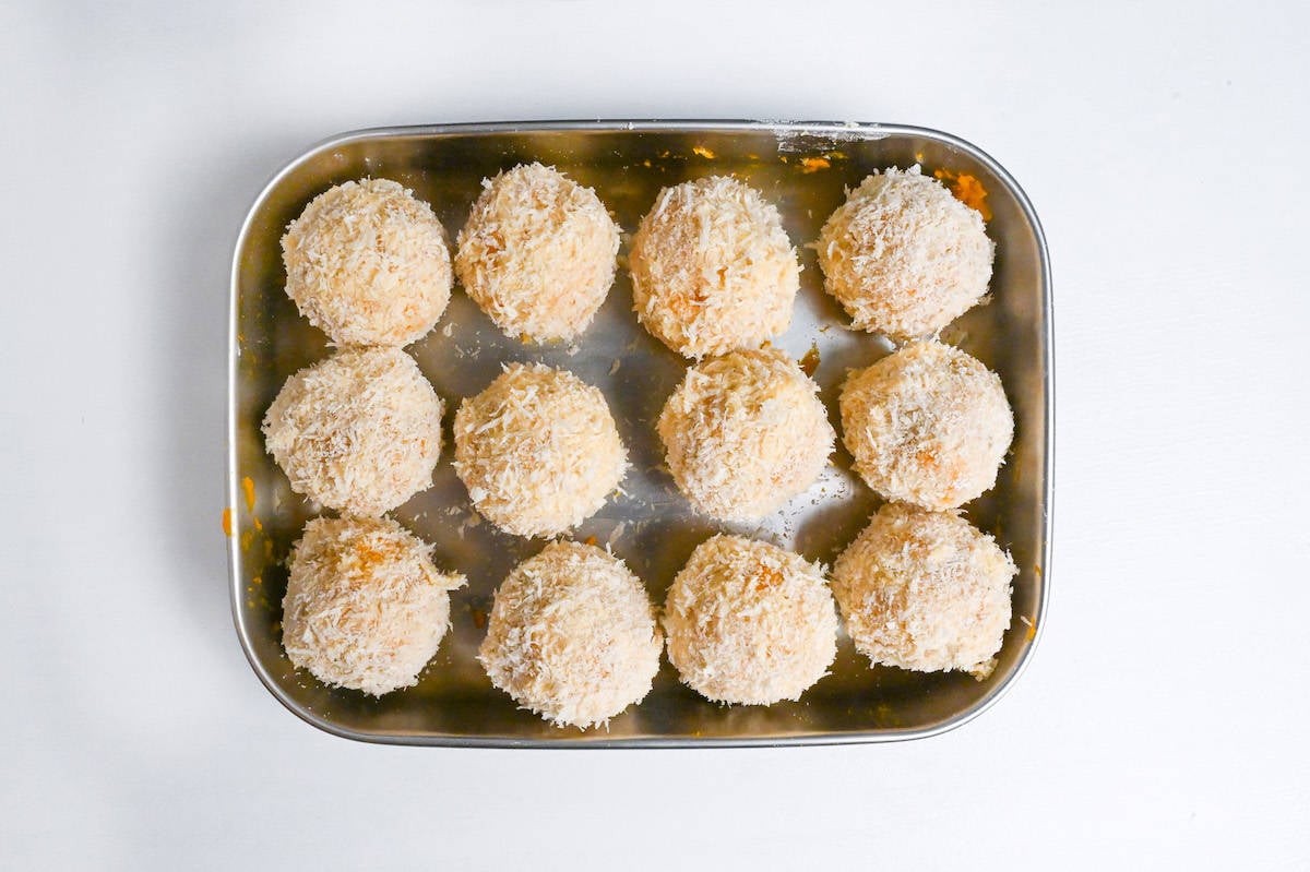 12 panko coated kabocha korokke in a steel container