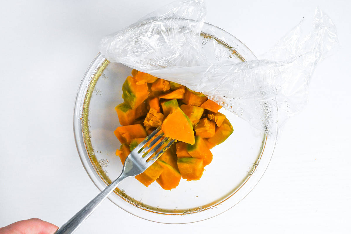 piercing microwaved kabocha with fork