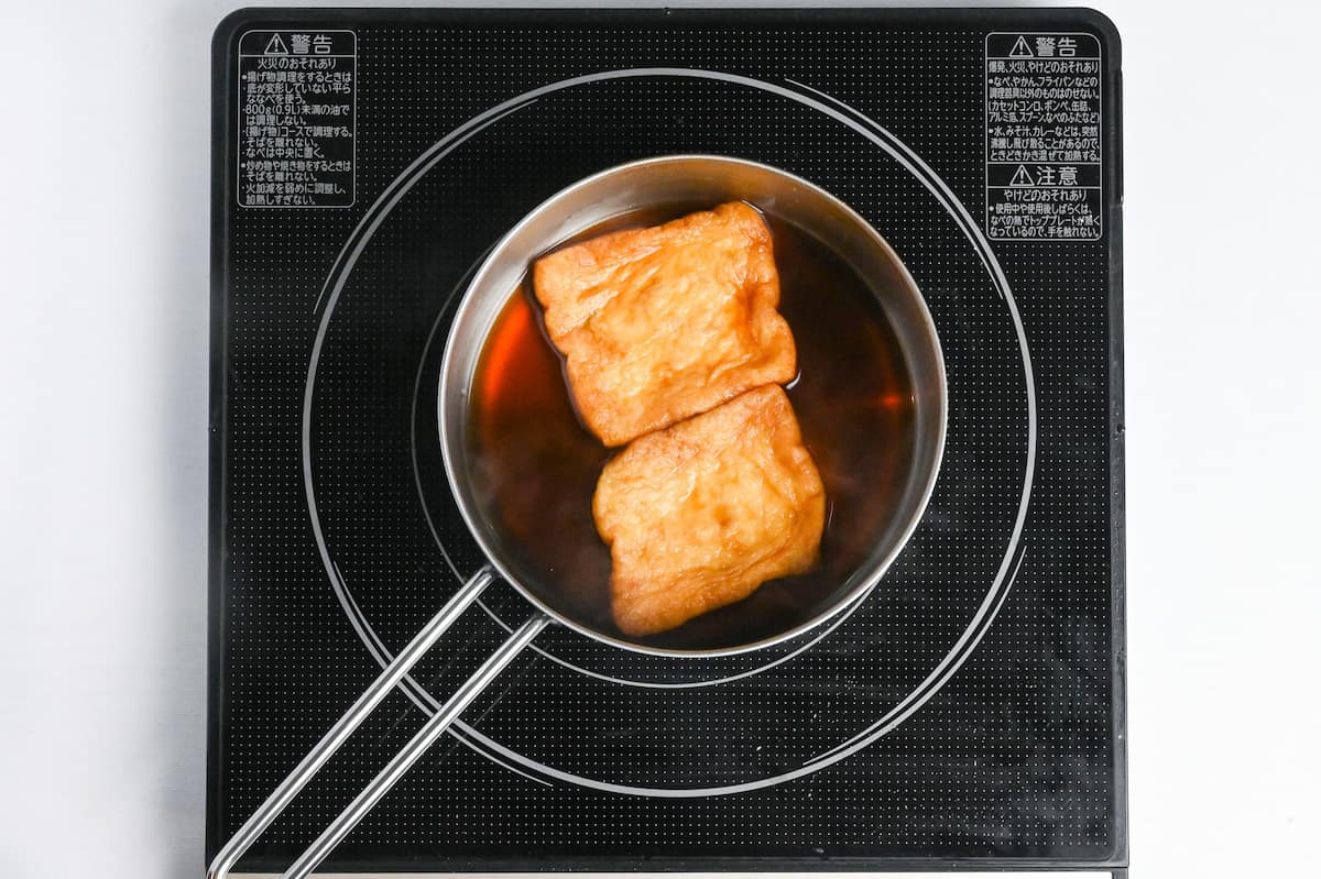 simmering deep fried tofu pouches in sauce