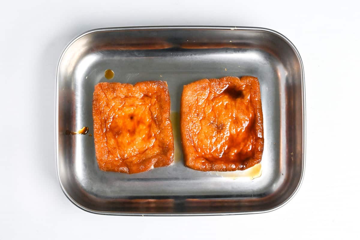 seasoned deep fried tofu pouches in a steel container