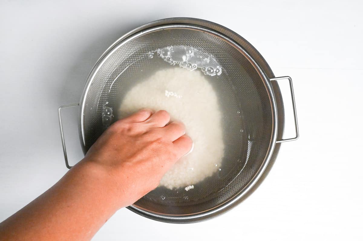 washing mochigome in a steel bowl