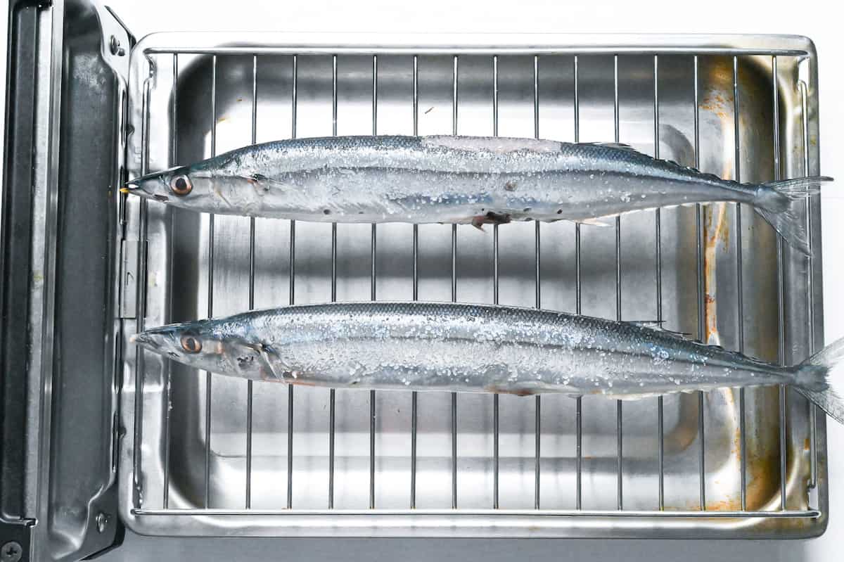 two salted pacific saury on a Japanese fish grill