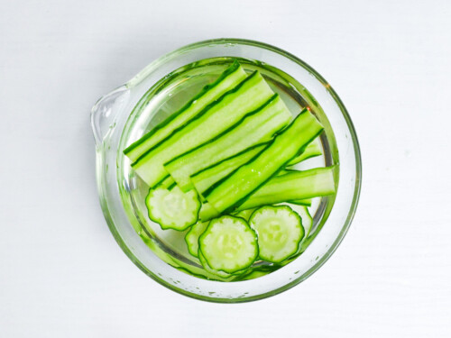 soaking thinly sliced cucumber in salt water to use for temari sushi