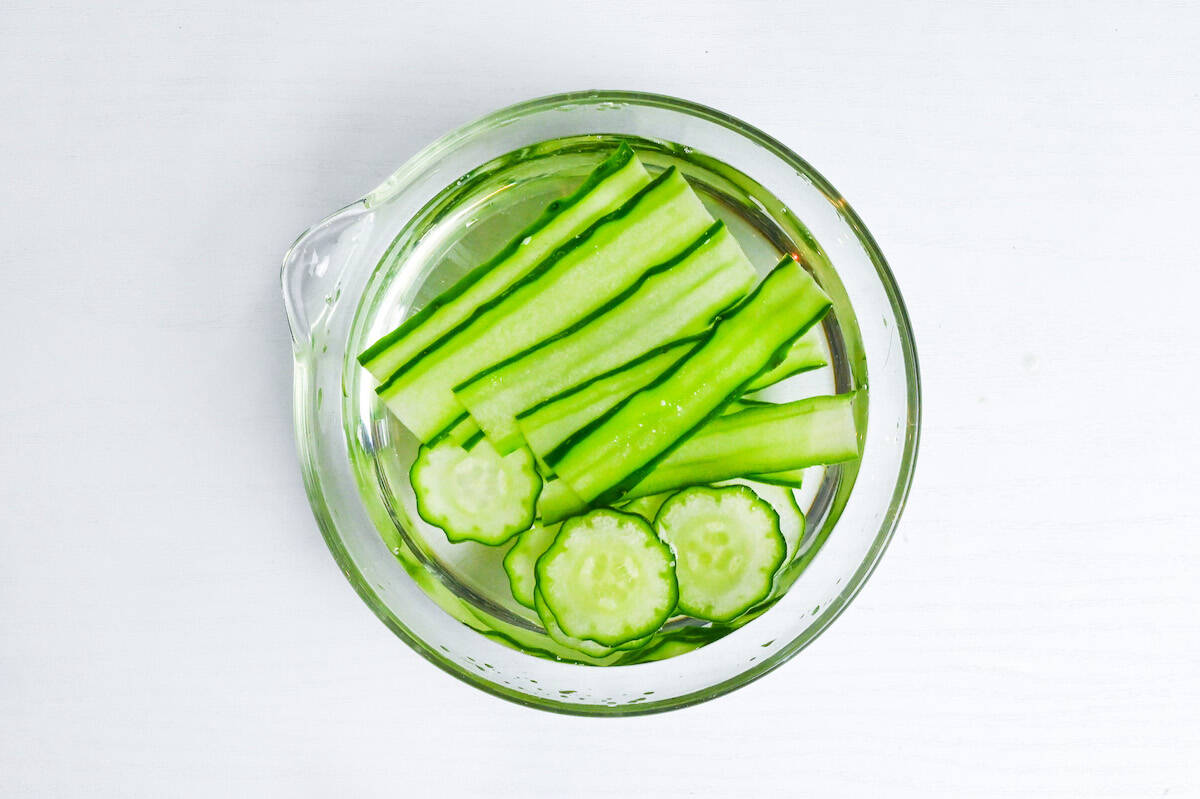 soaking thinly sliced cucumber in salt water to use for temari sushi