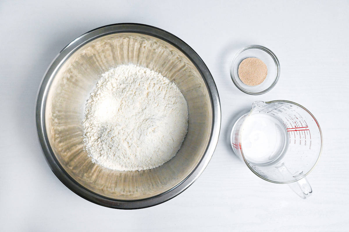 flour, yeast and water measured out to make pizza dough
