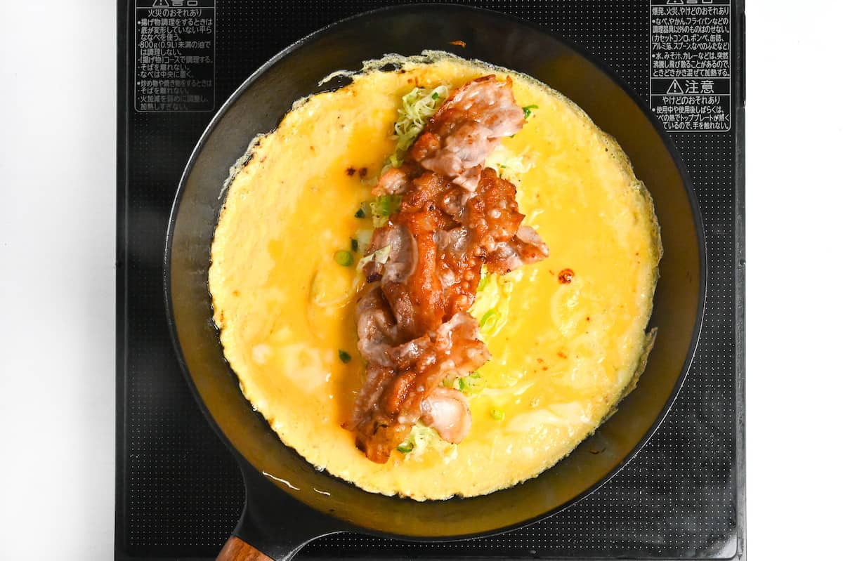 cabbage, green onion and crispy pork belly spread through the middle of omelette to make tonpeiyaki
