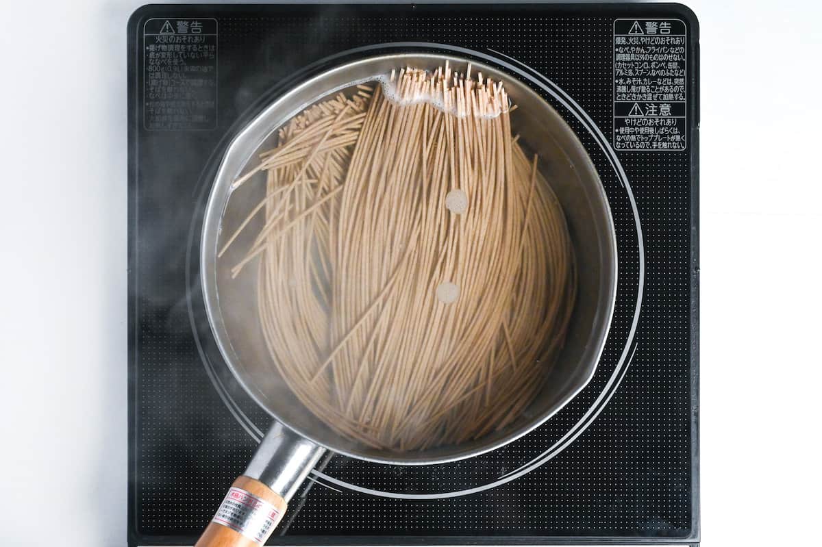boiling soba noodles in a pot of water
